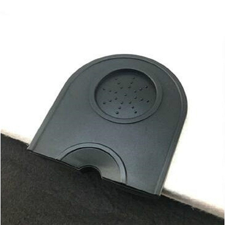 Dark gray/black corner coffee pad with embossed circular insert and front notch.