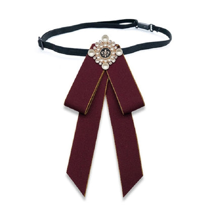 Maroon cloth bow-knot tie with pearl flower center, long tails on black neck strap