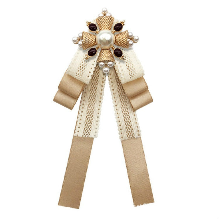 Champagne lace bow brooch with pearl center, gold accents, and layered ribbon tails
