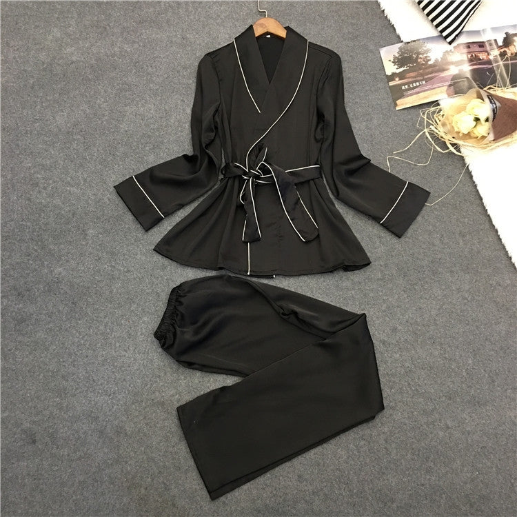 Silk-look black pajama set with V-neck robe top, white piping, and matching drawstring pants