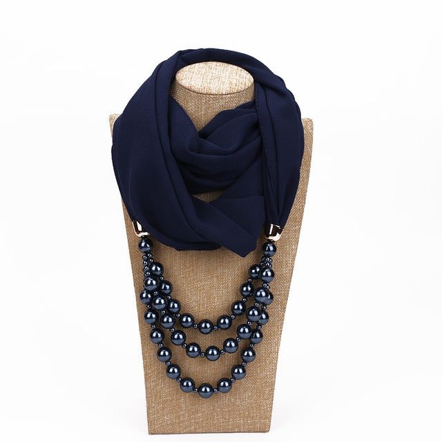 Navy scarf with black imitation pearl necklace, layered dark bead strings