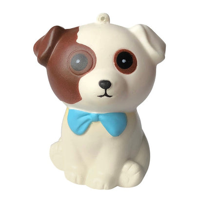 Squishy dog stress relief toy, cream body with brown patch and blue bow tie.