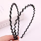 Two black wavy zigzag hair headbands with textured flexible edges