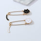 Cat brooch set: black and white cat designs on gold-toned safety pin backs