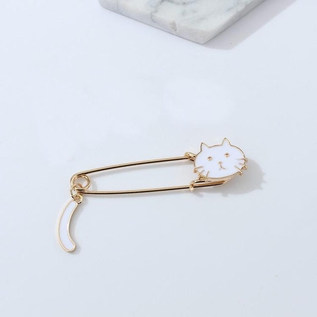 White cat enamel pin brooch with curled tail, gold-toned safety pin back