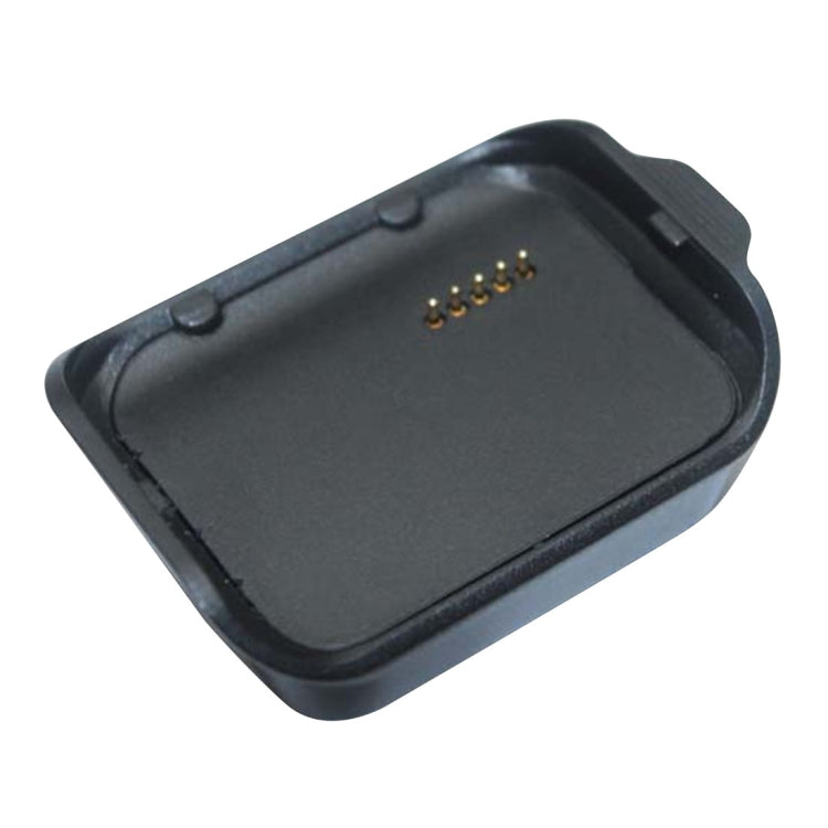 Black charging cradle base with gold contact pins, top view