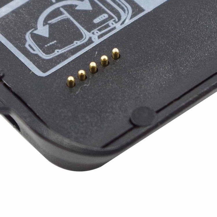 Close-up of gold charging contact pins on black cradle base