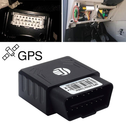Black OBD II GPS vehicle tracker module with connector opening, shown near car port