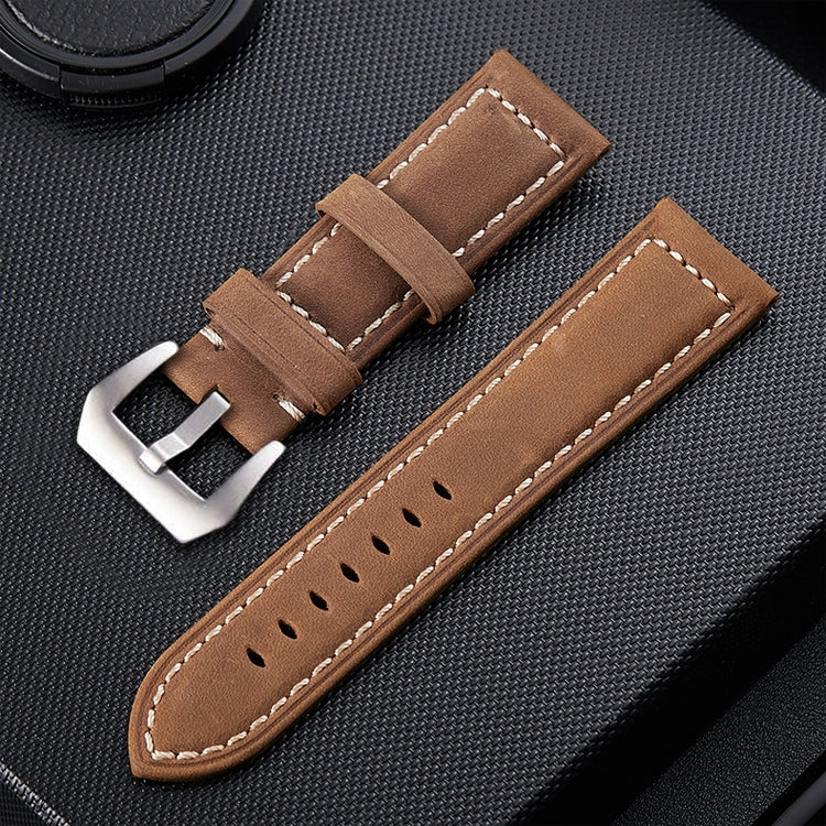 Light brown leather watch band with silver buckle, stitched trim, and punched hole pattern