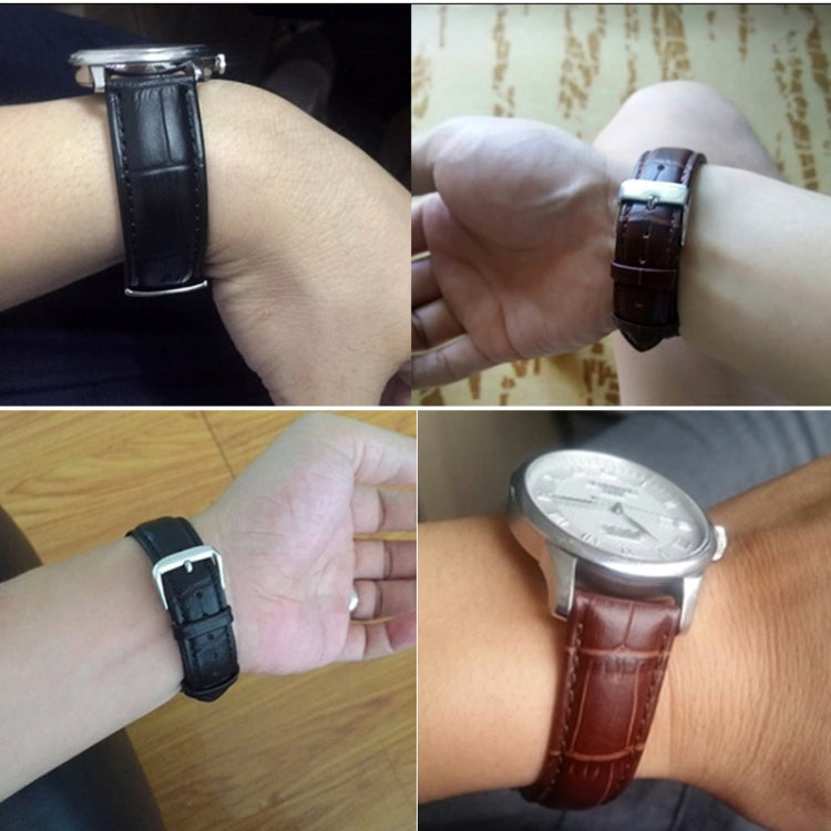 Leather watch band worn on wrist with metal buckle and stitched strap edge