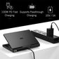 Handheld gaming PC on a stand with charging adapter cable connected, black