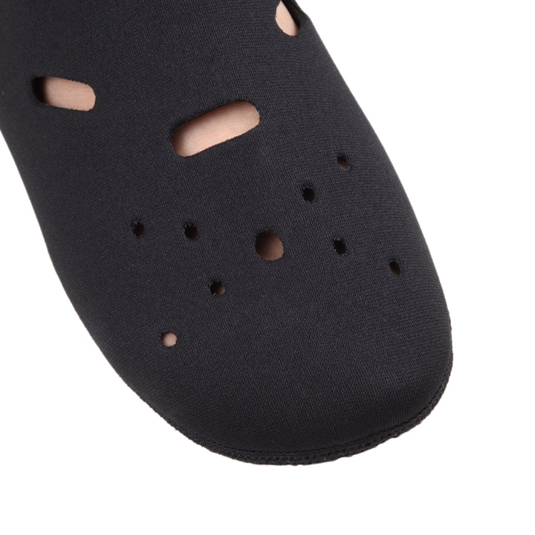 Close-up of black swim sock with perforation holes and open toe cutout