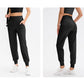 Women’s loose sports trousers, black, side pockets, elastic cuffs, two angles