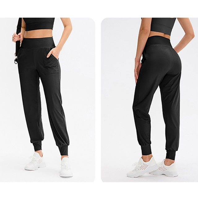 Women’s loose sports trousers, black, side pockets, elastic cuffs, two angles