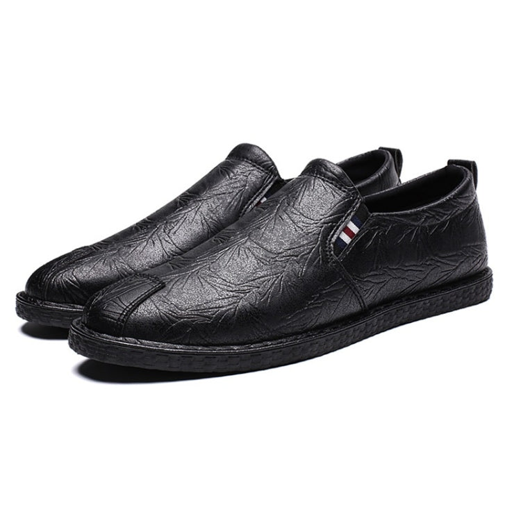 Black leather slip-on shoes with round toe and textured upper