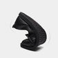 Black leather slip-on shoes with textured rubber sole and round toe