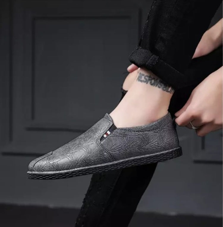 Gray leather slip-on shoes with round toe and side panel detail