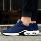 Men's blue mesh running shoe on foot with white sole and air-cushion detail