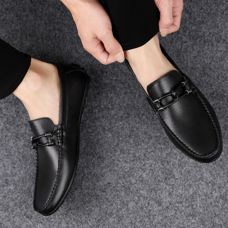 Pair of men's black round-toe loafers with strap and stitched moccasin-style sole