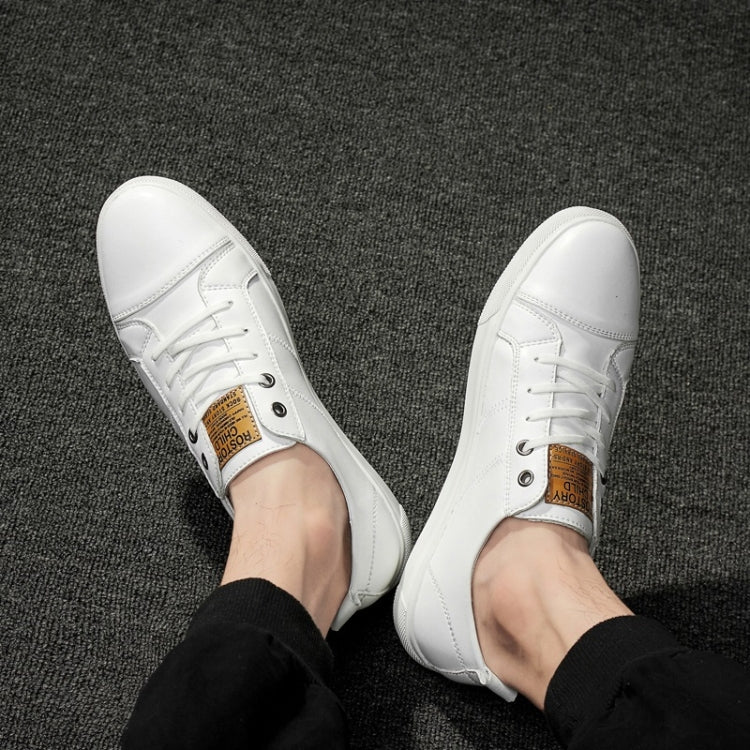 Men's white lace-up sneakers, top view with eyelets, laces, and tan brand label