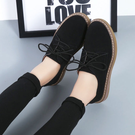 Women's black suede lace-up flats with contrast tan sole and stitched edge