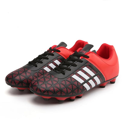 Red and black soccer shoes with black laces, striped side panels, and molded studs