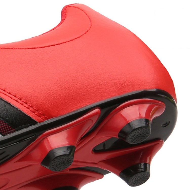 Red soccer shoe with black trim, side stripe detail, and molded forefoot studs