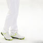 White golf sneakers with neon green trim worn with white pants