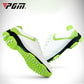 Side view of white golf sneakers with neon green trim and studded traction soles