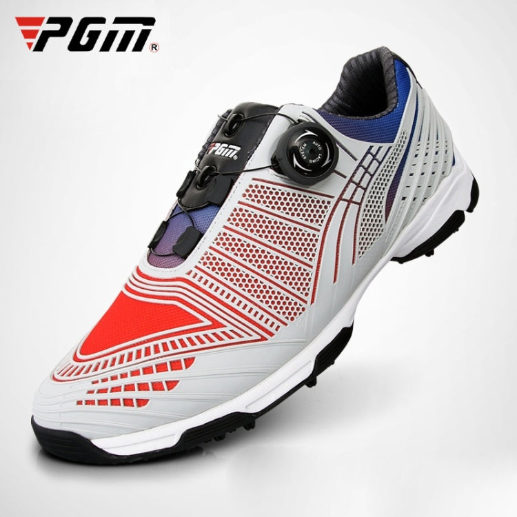 Lace-up golf sneakers with white upper, red perforated panels, black strap, blue collar.