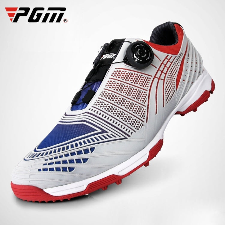 Lace-up golf sneakers with white upper, blue perforations, black strap, red outsole studs.