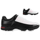Men's golf sneakers pair, black and white with red dot accents and cleated traction outsole