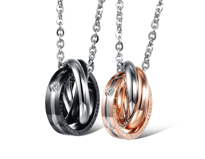 Pair of interlocking ring pendants in black and rose gold with silver link chains