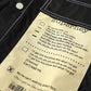 Men's black shirt jacket with beige printed fabric label on the chest panel