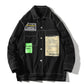 Men's black shirt jacket with long sleeves, button front, and chest logo tag panels