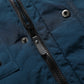 Blue jacket fabric close-up with front zipper and snap buttons at placket