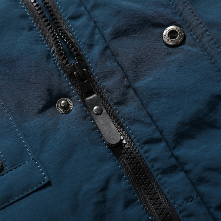 Blue jacket fabric close-up with front zipper and snap buttons at placket