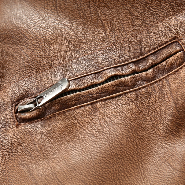 Tan leather jacket close-up of silver zipper pull and stitched seam