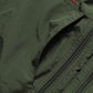 Dark green vest side pocket zipper and seam stitching close-up