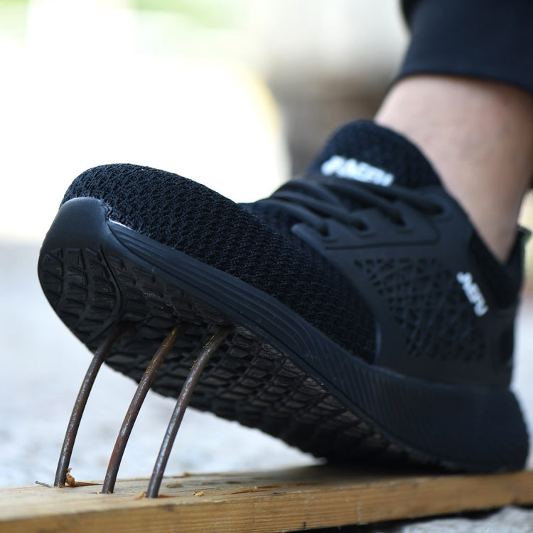 Black electrical-insulating work shoes on foot; outsole tread visible