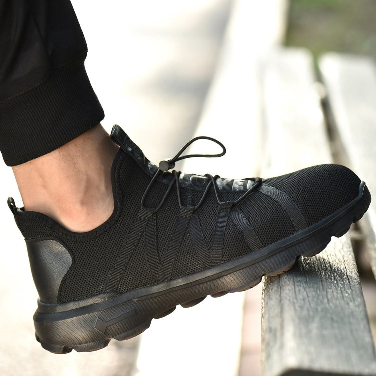 Black safety sneaker on foot with breathable upper and lace-up front