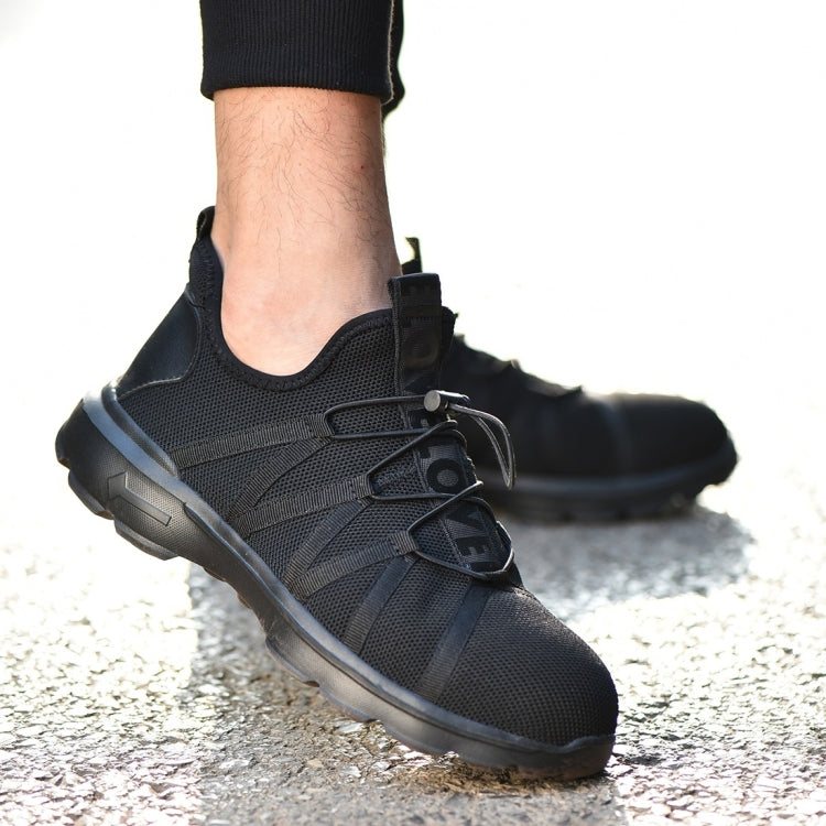 Black safety sneaker worn on foot with lace-up design and thick rubber sole