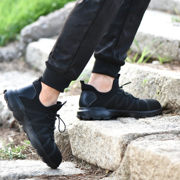 Black safety sneaker on foot with lace-up closure and durable outsole