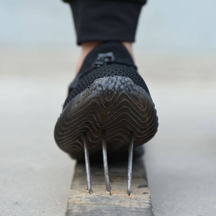 Rear view of black work safety shoe with thick sole and three spike-like toe points