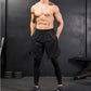 Black workout pants set with baggy shorts overlaying fitted compression leggings.