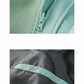 Storm jacket fabric close-up with mint green zipper and contrast stitching